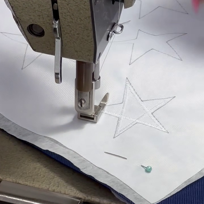 Detailed sewing of stars on an Australian flag, showcasing quality workmanship and expert finishing